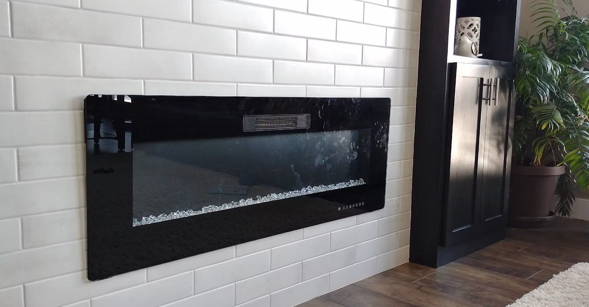 Modern linear electric fireplace in white shiplap accent wall