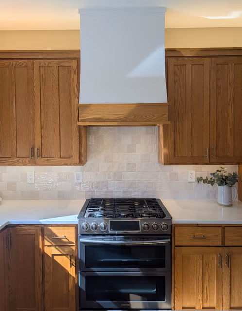 Celebration kitchen with upper and lower cabinet LED lighting highlighting the tiled backsplash