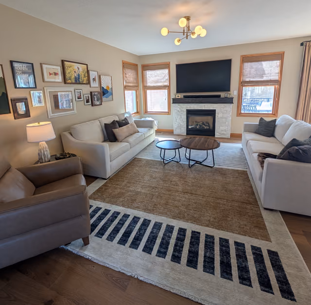 Celebration living room with curated seating and a gallery wall of kids artwork, family photos and found textile art
