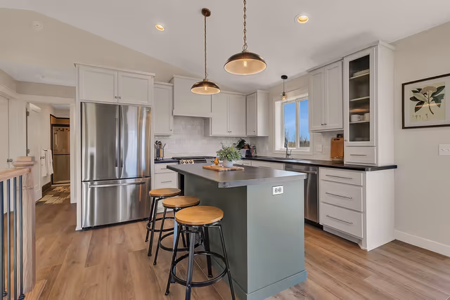 Kitchen — hand-crafted staggered height and depth cabinetry with an accent green island — Foley, MN remodel by Simply Enhanced Homes