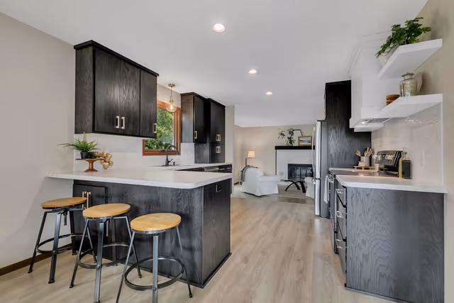 Kitchen — flat-front ebony-stained custom cabinetry with white tiled backsplash — St. Cloud, MN remodel by Simply Enhanced Homes