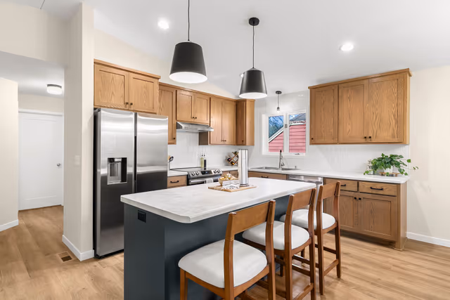 Kitchen — center wall removed to open the kitchen to the living area, with a new large island with seating — St. Cloud, MN remodel by Simply Enhanced Homes