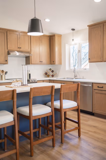 Kitchen — natural stain on red oak with a contrasting painted island and stainless steel appliances — St. Cloud, MN remodel by Simply Enhanced Homes