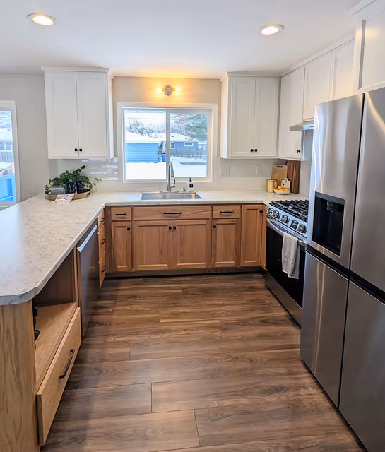 Kitchen — custom-built two-tone cabinetry with stainless steel appliances — St. Cloud, MN remodel by Simply Enhanced Homes